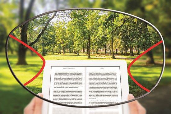 Representação da lente multifocal, cantos embaçados e o centro com a imagem de um parque e um livro em foco